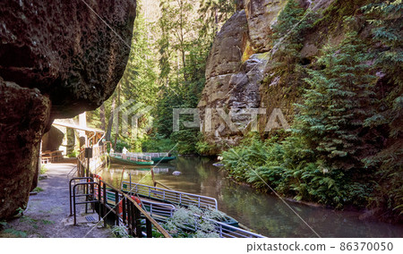 Landing stage for excursion boats through the gorge of the Kirnitzsch, the border river between Germany and Czech Republic near Hinterhermsdorf in Saxon Switzerland 86370050