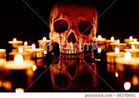 Blood stained skull against dark background closeup 86370091