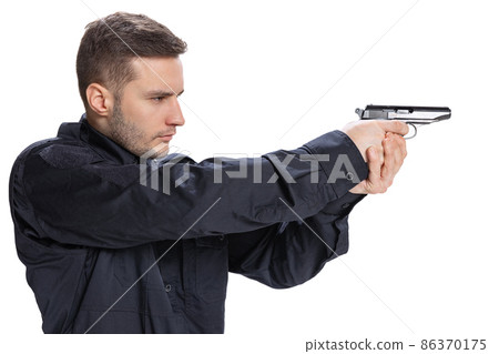Half-length portrait of young man, policeman officer wearing black uniform standing with gun isolated on white background. Concept of job, caree, law and order. Half-length portrait of young man, policeman officer wearing black uniform standing with gun isolated on white background. Concept of job, caree, law and order. 86370175