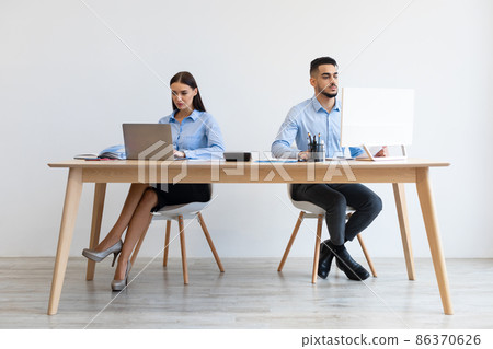 Portrait Of Focused Colleagues Working At Office Together Portrait Of Focused Colleagues Working At Office Together 86370626