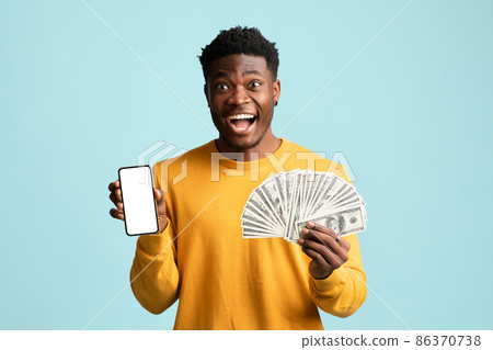 Handsome african american young man showing cellphone and cash, mockup Handsome african american young man showing cellphone and cash, mockup 86370738