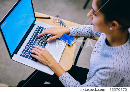 Crop woman working on netbook Crop woman working on netbook 86370870
