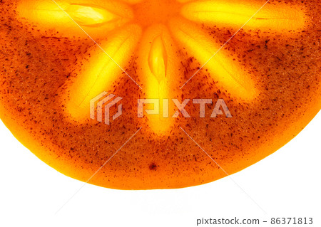 Close-up of a piece of fresh ripe persimmon, half a round slice on an isolated white background.Bright light in the middle of the fruit. High quality photo Close-up of a piece of fresh ripe persimmon, half a round slice on an isolated white background.Bright light in the middle of the fruit. High quality photo 86371813