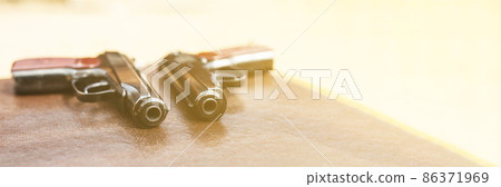 pistol lies on the table 86371969