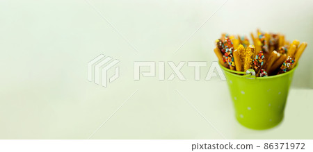 green bucket with sweets 86371972