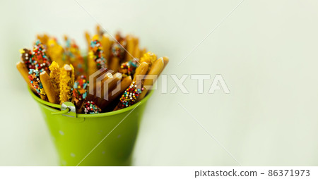 green bucket with sweets 86371973