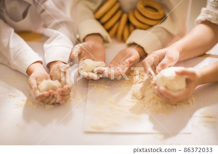 Hands close-up of happy young children in the form of a chef to cook a delicious 86372033