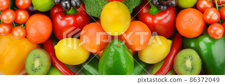 Bright background from vegetables and fruits. Wide photo. 86372049