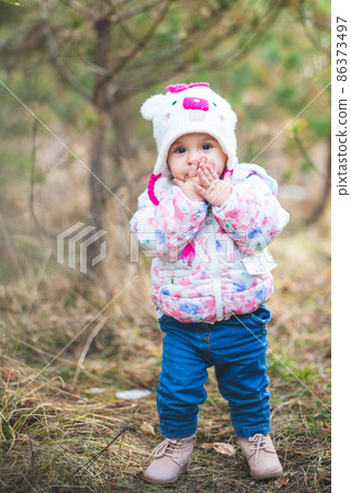 Portrait of little toddler girl having fun outdoors in cold weather at mountains Portrait of little toddler girl having fun outdoors in cold weather at mountains 86373497