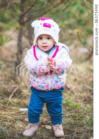 Portrait of little toddler girl having fun outdoors in cold weather at mountains Portrait of little toddler girl having fun outdoors in cold weather at mountains 86373498