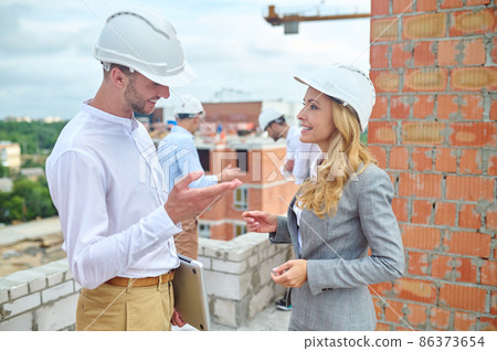 Joyous building inspector talking to a young foreman Joyous building inspector talking to a young foreman 86373654