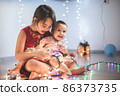 Little sisters having fun at home with chrismass lights. 86373735