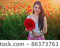 beautiful girl in a poppy field at sunset 86373761