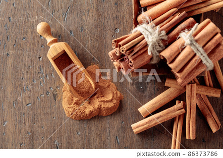 Cinnamon sticks and powder on a wooden table. Cinnamon sticks and powder on a wooden table. 86373786