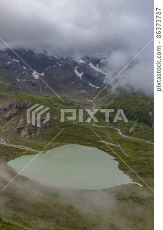 Typical alpine landscape of Swiss Alps with Steinsee, Urner Alps, Canton of Bern, Switzerland 86373787