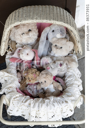 stuffed toys in the old fashioned buggy 86373931