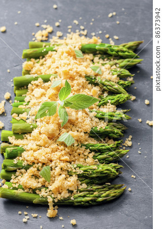 parmesan and breadcrumbs on green asparagus 86373942