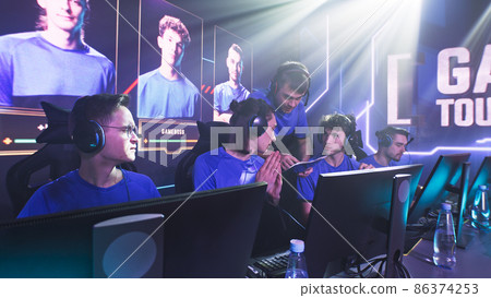 Young cyber sportsmen discussing strategy with coach Young cyber sportsmen discussing strategy with coach 86374253