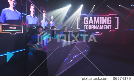 Young gamers putting on headphones at start of match Young gamers putting on headphones at start of match 86374379
