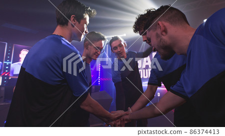 Male gamers staking hands together Male gamers staking hands together 86374413