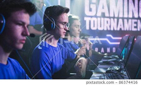 Young gamers putting on headphones before match Young gamers putting on headphones before match 86374416