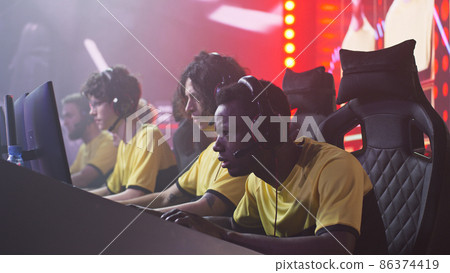 Focused male gamer taking part in gaming tournament 86374419