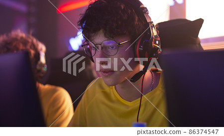 Teen cyber sportsman during gaming tournament Teen cyber sportsman during gaming tournament 86374547