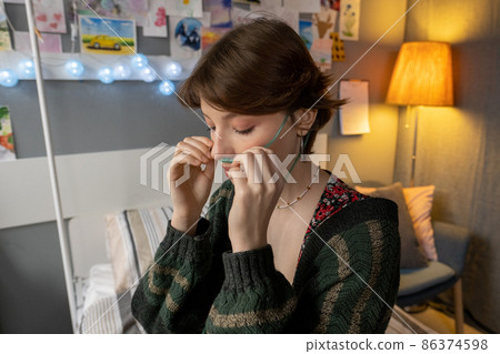 Young woman breathing with oxygen tube Young woman breathing with oxygen tube 86374598