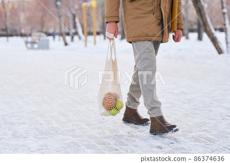 Man going home after shopping 86374636