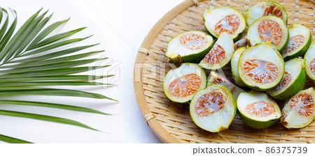 Betel nut in bamboo basket on white background. 86375739