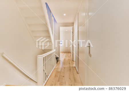 Luxurious long corridor with white staircase and parquet floor 86376029