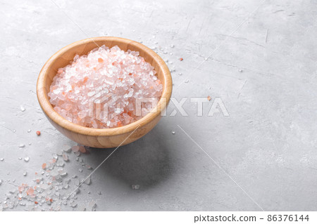 pink Himalayan salt in a bowl on a light background. Top view. 86376144