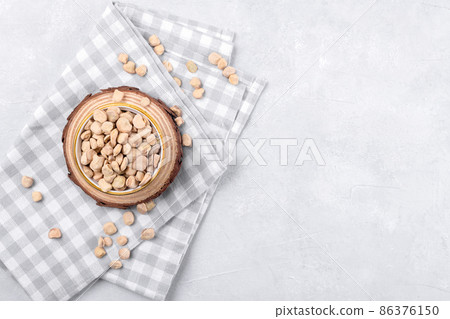 Cicerchia or indian pea on a ceramic bowl with napkin on grey table background, close up, gluten free food 86376150