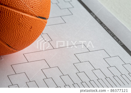 Blank bracket grid on white paper with basketball on top Blank bracket grid on white paper with basketball on top 86377121