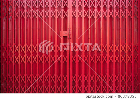Close-up red old metal slide shutter front door of home with rusty and grunge texture for background. 86378353