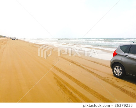 A view of a car driving along the coast A view of a car driving along the coast 86379233