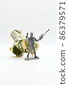 Plastic soldier with American dollars behind him. 86379571