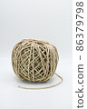 Roll of natural brown decorative string. 86379798
