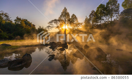 Hot springs and fog in Thailand with sunlight at morning, Sunrise above hot spring nature background, Hot springs in Chae Son National Park, Lampang, Thailand. 86380055