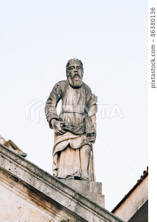 Sculpture of a man with a book on the Church of Saint apostle Mark. Montenegro Sculpture of a man with a book on the Church of Saint apostle Mark. Montenegro 86380136