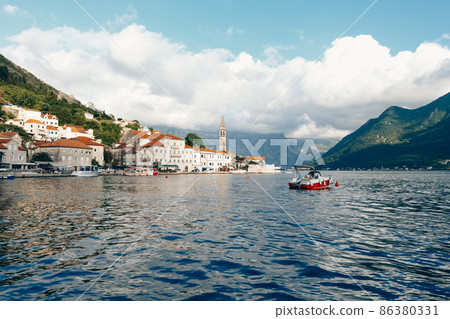 Stone houses with tiled roofs on the Perast embankment. Montenegro 86380331