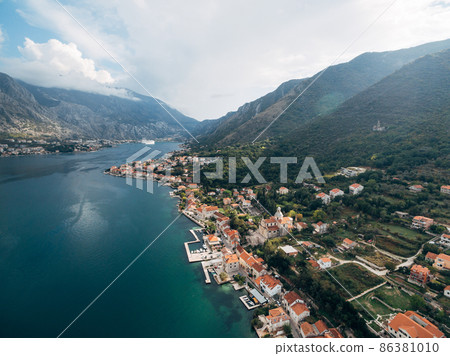 Aerial view of the town of Prcanj on the shore of the Bay of Kotor Aerial view of the town of Prcanj on the shore of the Bay of Kotor 86381010