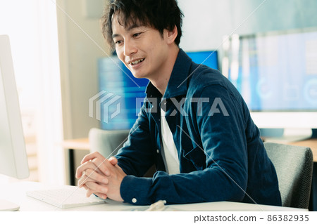 A man heading to a computer A man heading to a computer 86382935