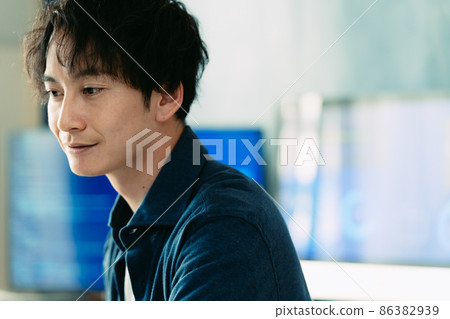 A man heading to a computer A man heading to a computer 86382939