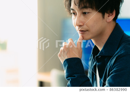 A man heading to a computer 86382990