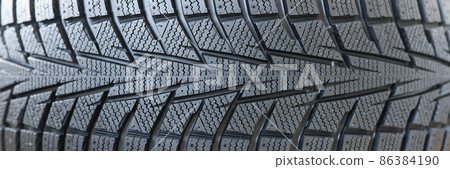 Stack of new black car tires with tread closeup 86384190
