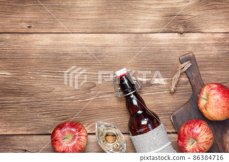 Apple cider vinegar, salad dressing, homemade fruit wine. Food fermented supplement. Wooden background with copy space Apple cider vinegar, salad dressing, homemade fruit wine. Food fermented supplement. Wooden background with copy space 86384716