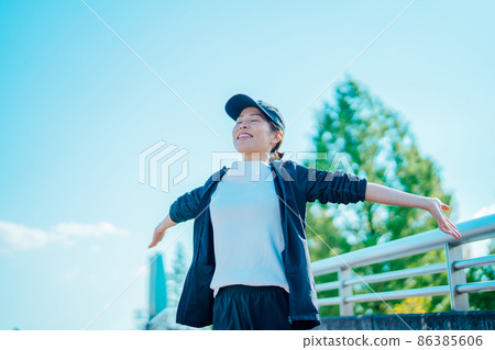 Female (stretching) preparatory exercise in the park Female (stretching) preparatory exercise in the park 86385606