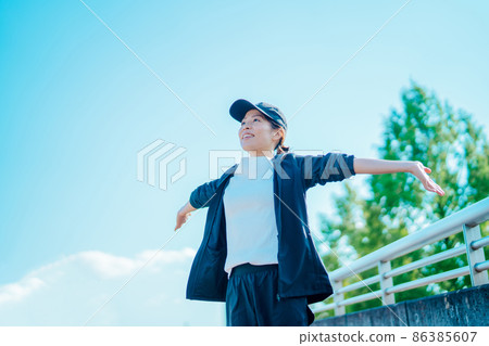 Female (stretching) preparatory exercise in the park Female (stretching) preparatory exercise in the park 86385607