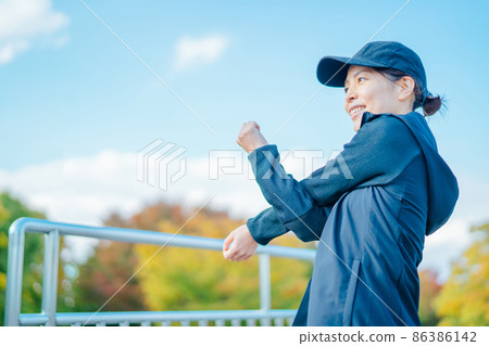 Female (stretching) preparatory exercise in the park Female (stretching) preparatory exercise in the park 86386142